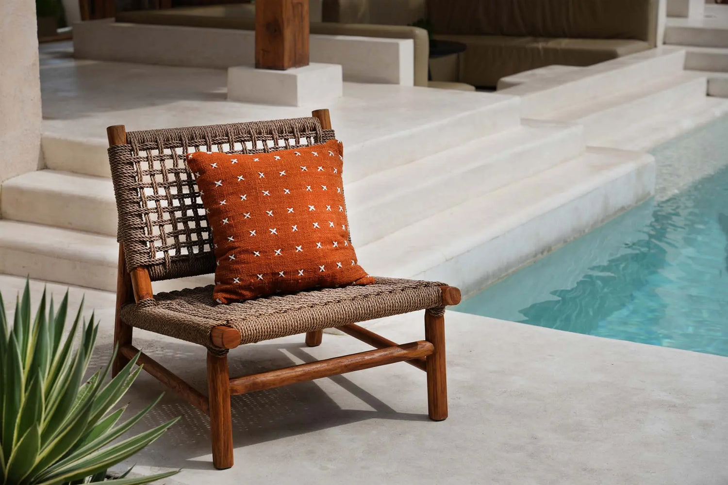 Housse de coussin terracotta coton  sur fauteuil au bord d'une piscine